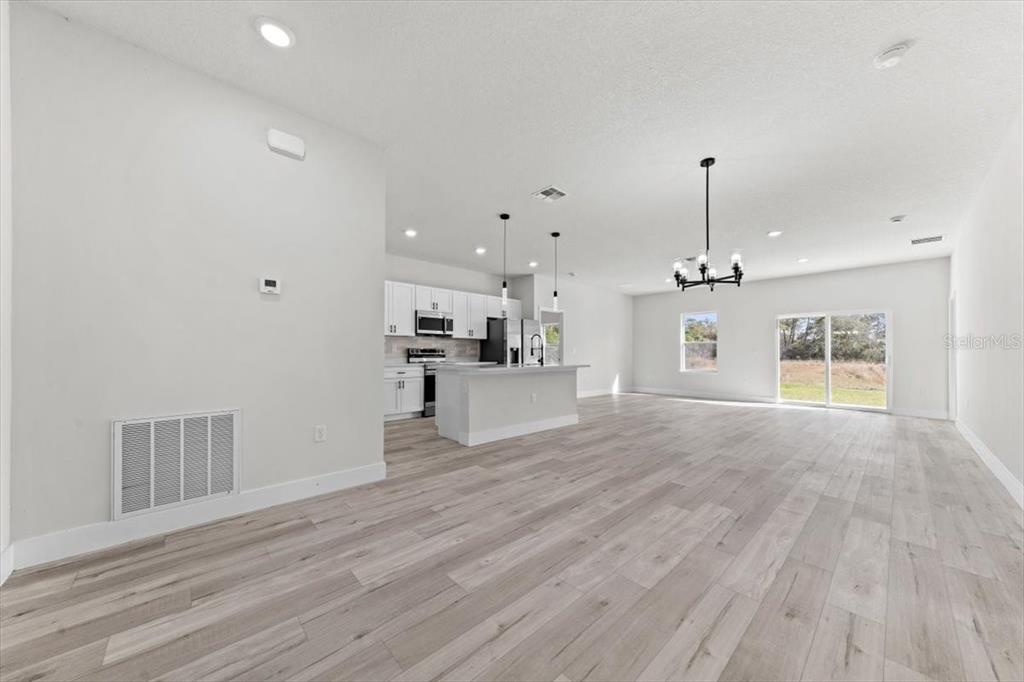 15495 Southwest 49th Avenue Road Ocala, FL 34473 - Photo 10 of 65 a view of kitchen and hall with wooden floor