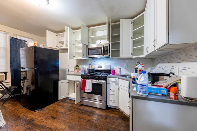 a kitchen with stainless steel appliances granite countertop a refrigerator stove and sink