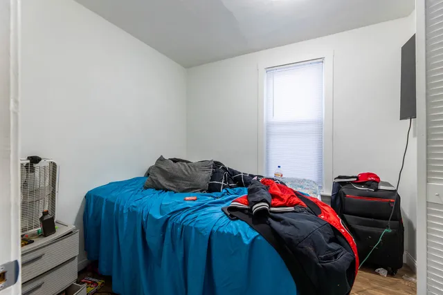a bedroom with a bed and a window