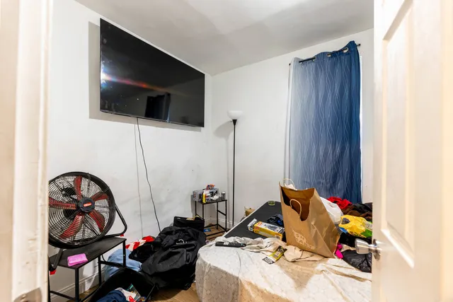 a room with storage and a flat screen tv