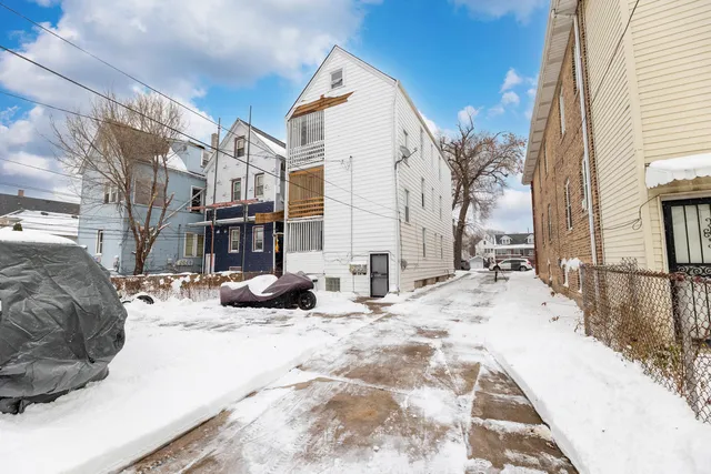 a view of a white house with large windows