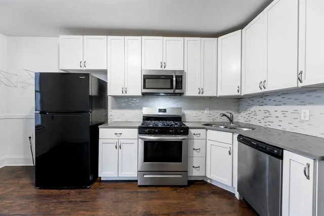 a kitchen with a stove and a refrigerator