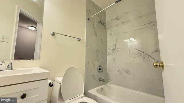 a bathroom with a tub a sink and a shower