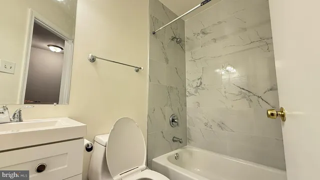 a bathroom with a tub a sink and a shower