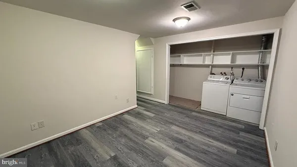 a room with a wooden floor and white walls