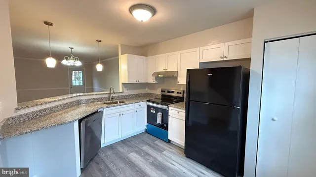 a kitchen with a refrigerator a sink and dishwasher