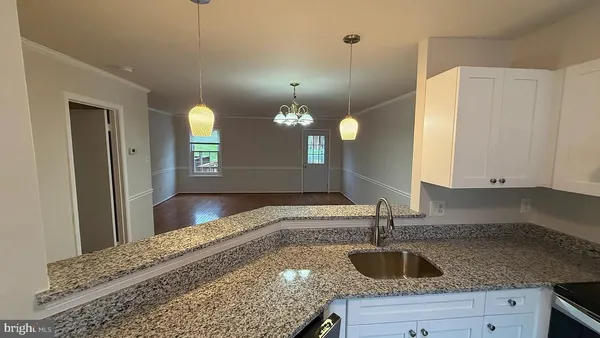 a kitchen with a sink and chandelier