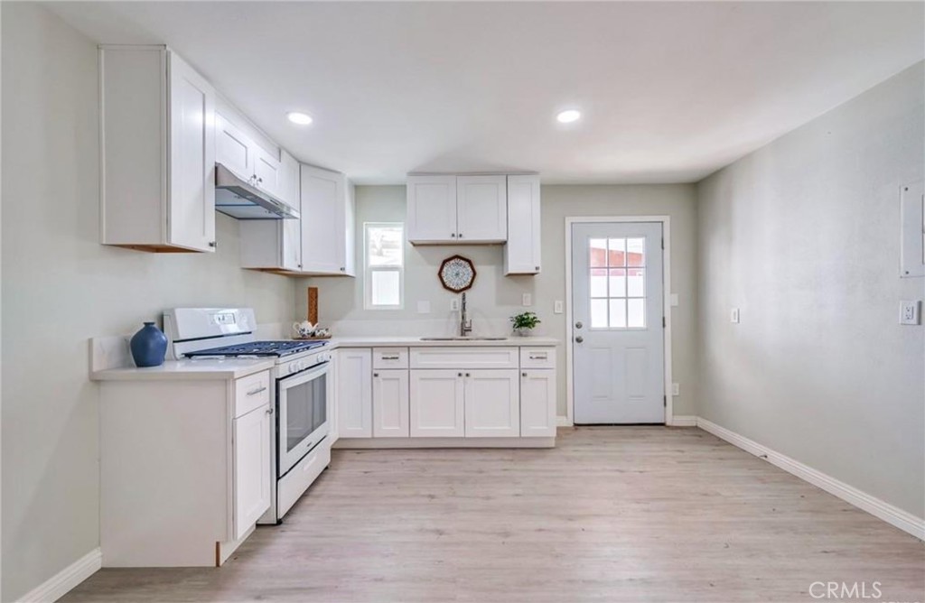 5510 Bushnell Avenue Riverside, CA 92505 - Photo 2 of 8 a kitchen with granite countertop white cabinets and white appliances