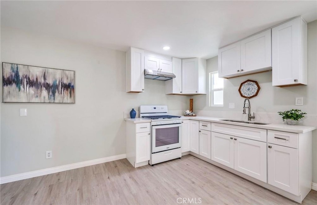 5510 Bushnell Avenue Riverside, CA 92505 - Photo 3 of 8 a kitchen with a sink cabinets and wooden floor