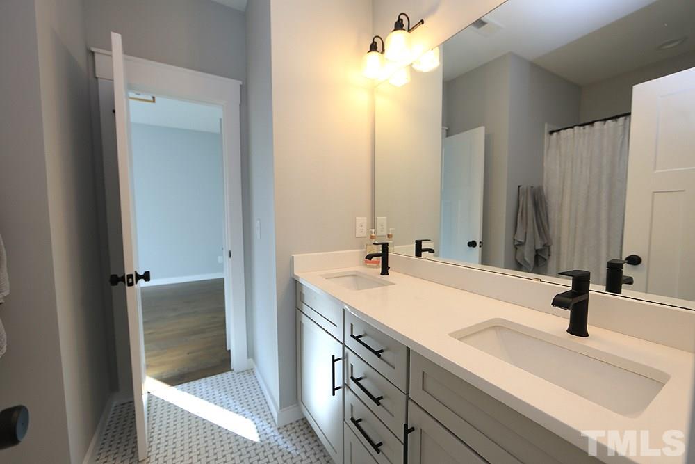 521 Bart Street Raleigh, NC 27610 - Photo 22 of 29 a bathroom with a sink and a mirror