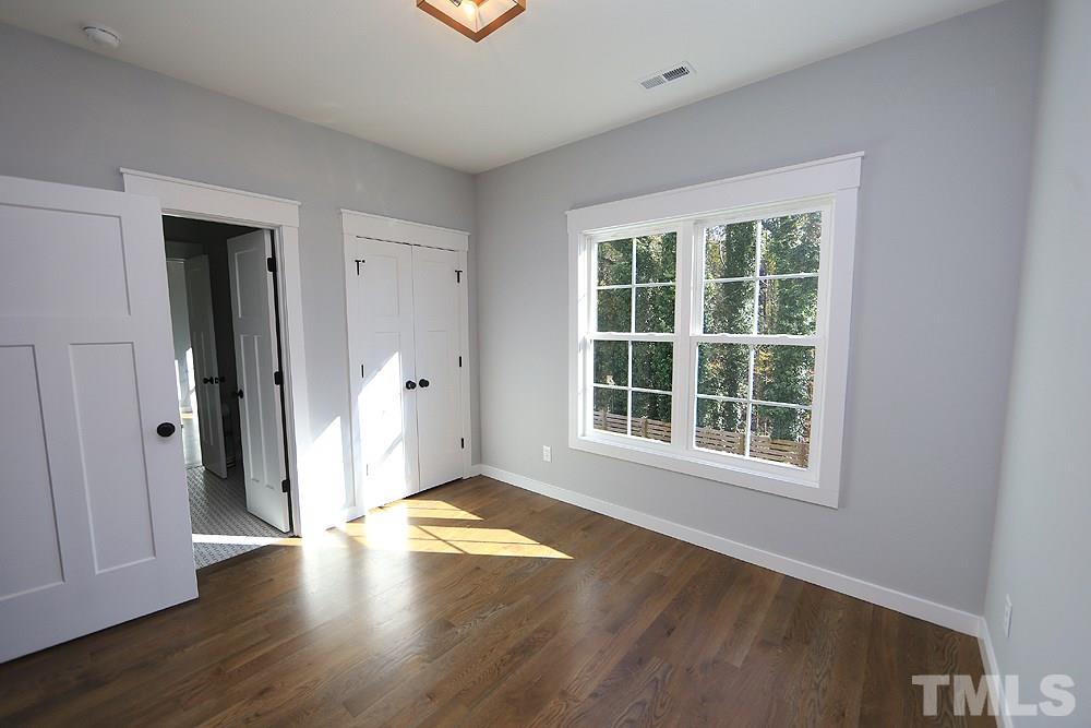 521 Bart Street Raleigh, NC 27610 - Photo 23 of 29 an empty room with wooden floor and windows