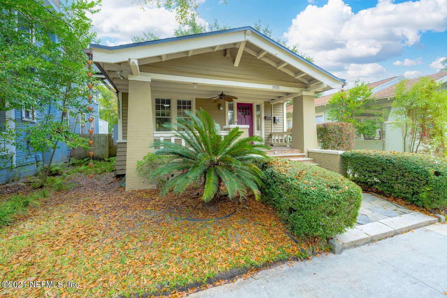 front view of a house with potted plants
