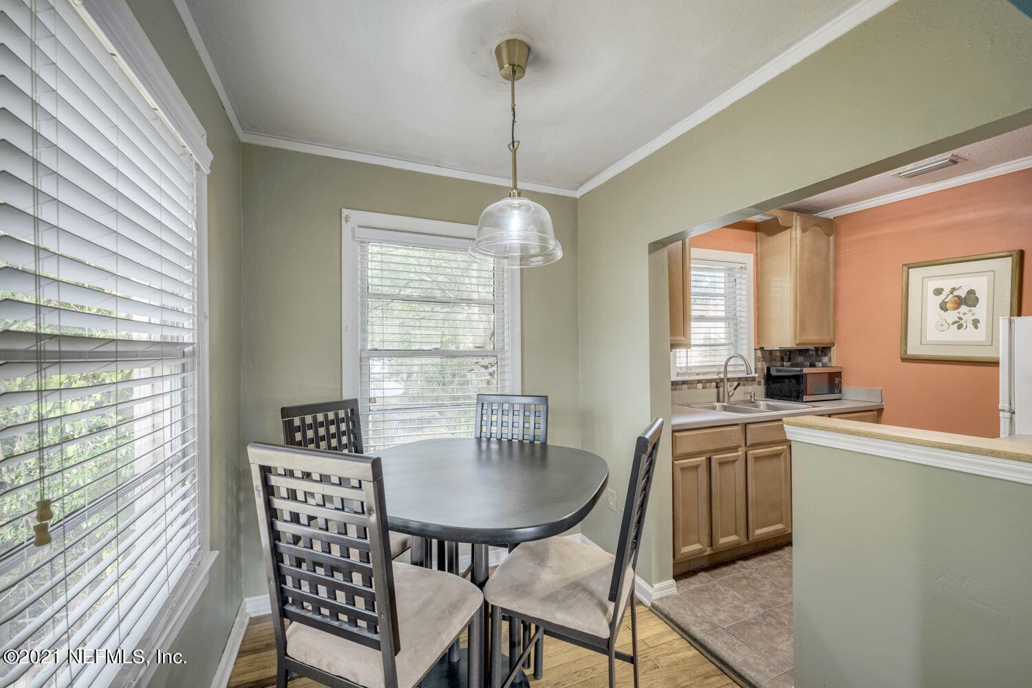 2835 Post Street Jacksonville, FL 32205 - Photo 24 of 30 a kitchen with a dining table chairs and large windows