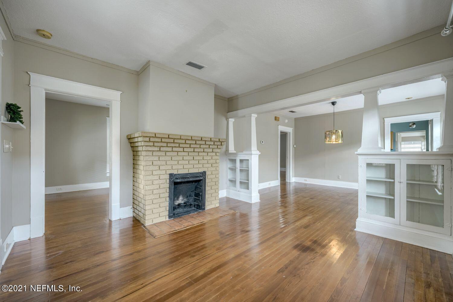 2835 Post Street Jacksonville, FL 32205 - Photo 4 of 30 an empty room with wooden floor and fireplace