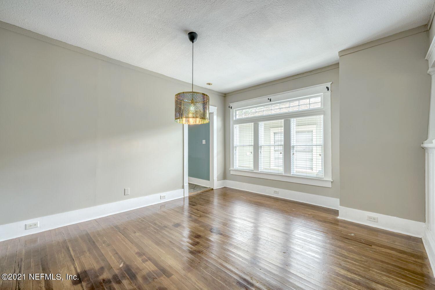 2835 Post Street Jacksonville, FL 32205 - Photo 7 of 30 a view of an empty room with wooden floor fridge and a window