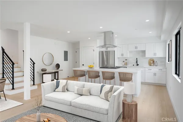 a living room with furniture white walls and white cabinets
