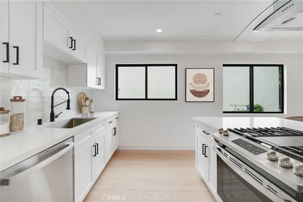a kitchen with stainless steel appliances a sink and a stove