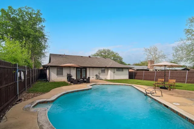 a view of a house with backyard porch and sitting area