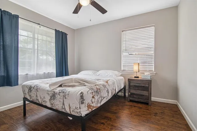 a bedroom with a bed and a large window