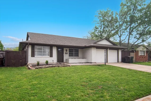 a front view of a house with a yard and trees