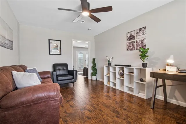 a living room with furniture and wooden floor