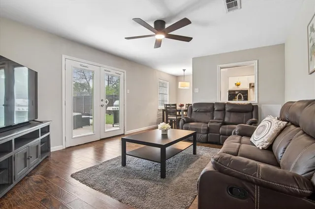 a living room with furniture and a wooden floor