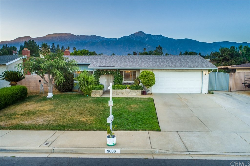 9836 Holly Street Rancho Cucamonga, CA 91701 - Photo 1 of 1 a view of a house with a yard and a garden