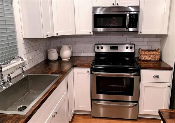 a kitchen with a stove and a microwave