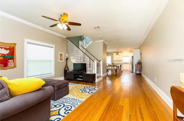 a living room with furniture and a wooden floor