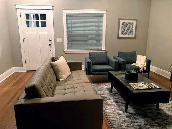 a living room with furniture and a window