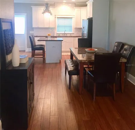 a view of a dining room with furniture and wooden floor