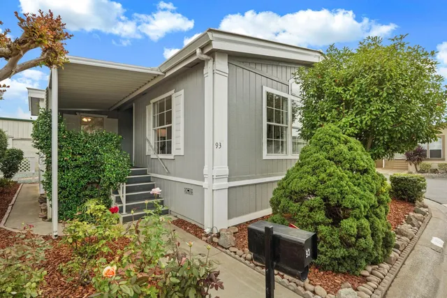 a view of a house with backyard and sitting area