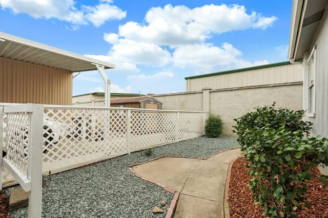 a view of swimming pool with outdoor space and trees in the background
