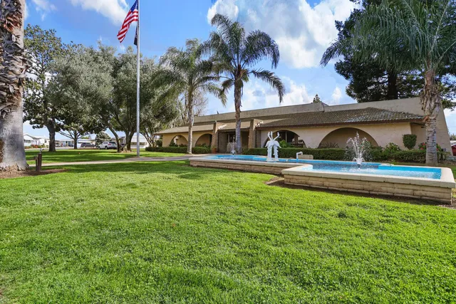 a room with pool table and windows