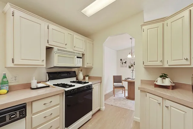 a kitchen with stainless steel appliances granite countertop a sink stove and cabinets