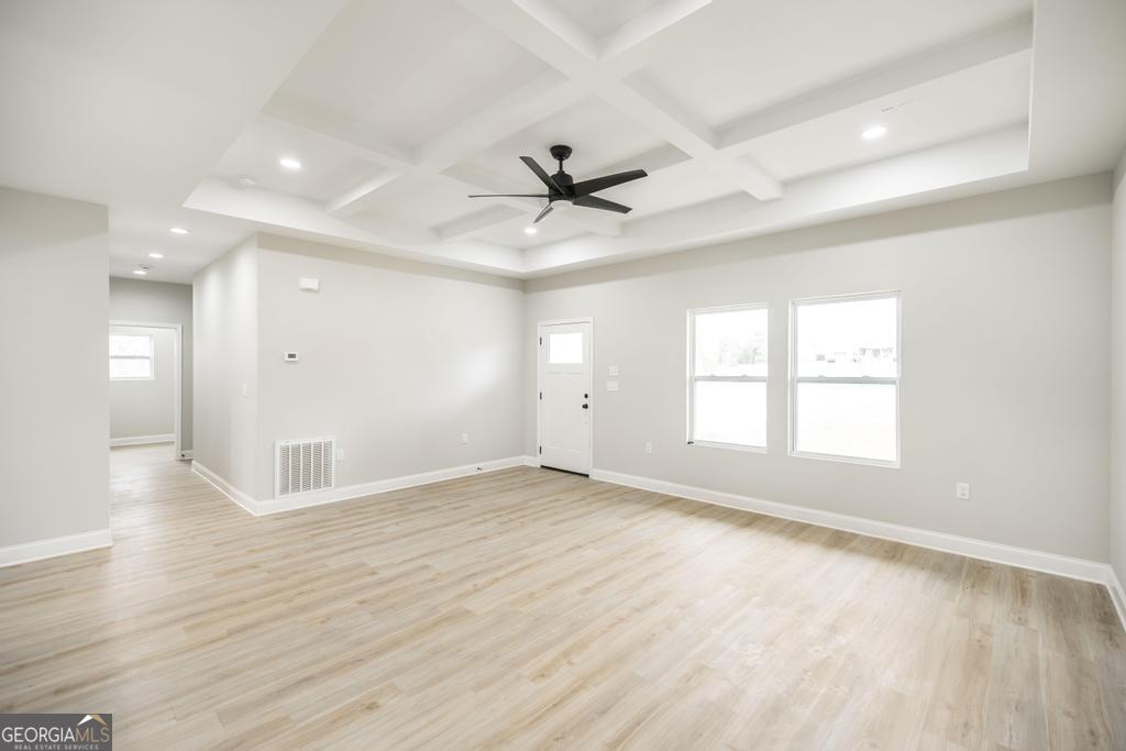 212 Lovett Farm Road East Dublin, GA 31027 - Photo 11 of 26 wooden floor in an empty room with a window