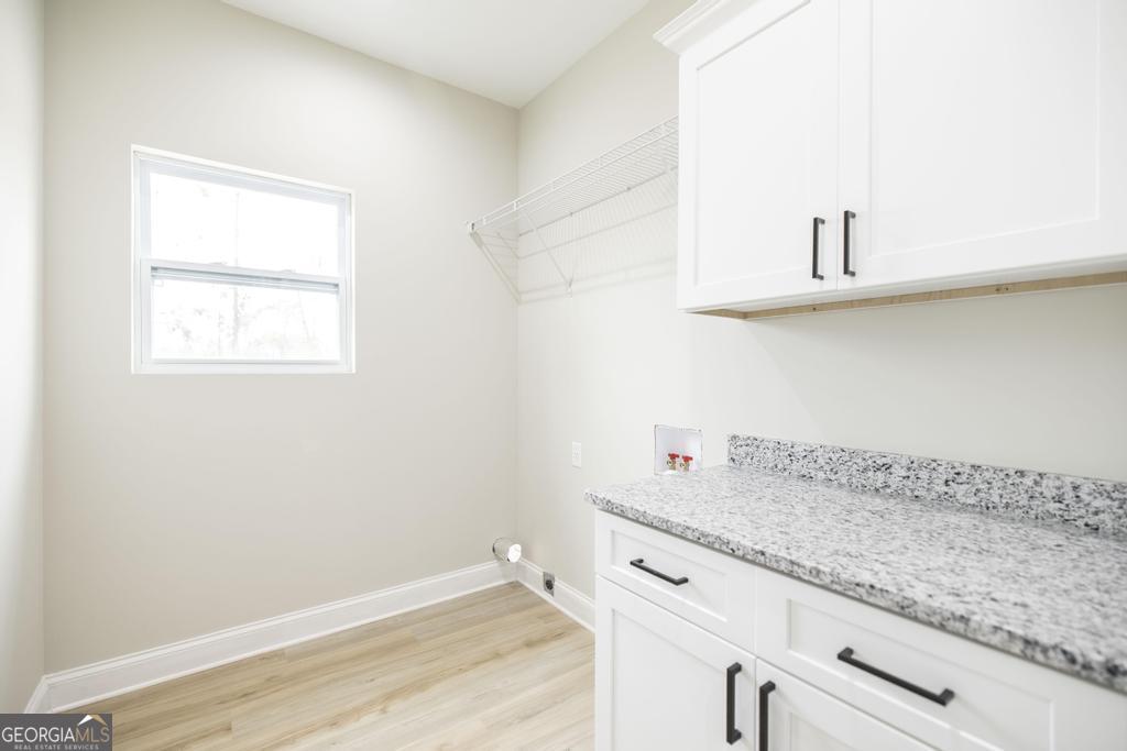 212 Lovett Farm Road East Dublin, GA 31027 - Photo 16 of 26 a view of granite countertop white cabinets and a wooden floor