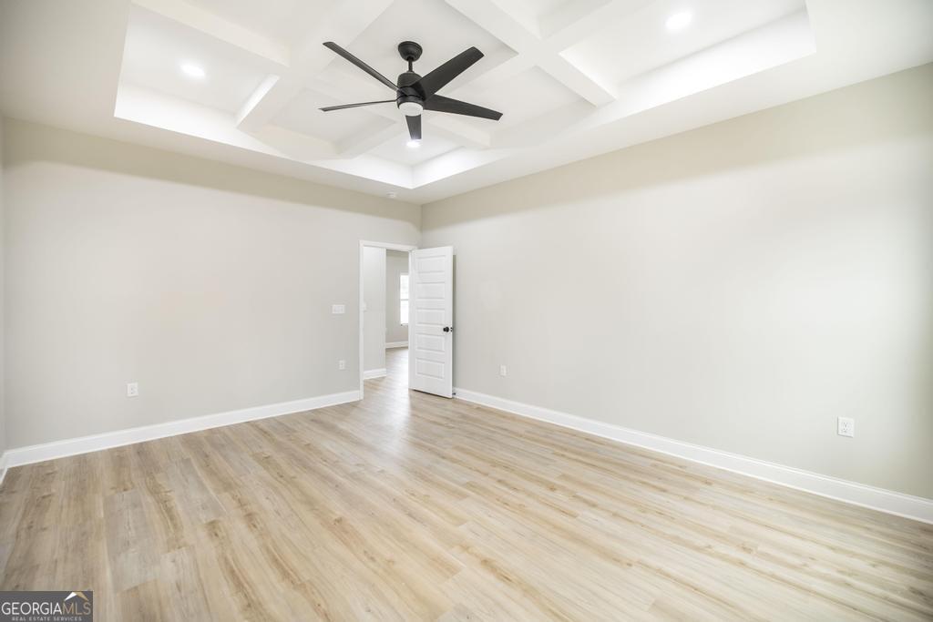 212 Lovett Farm Road East Dublin, GA 31027 - Photo 18 of 26 an empty room with wooden floor and windows