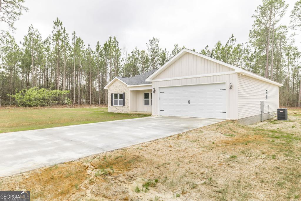 212 Lovett Farm Road East Dublin, GA 31027 - Photo 2 of 26 a view of garage and yard