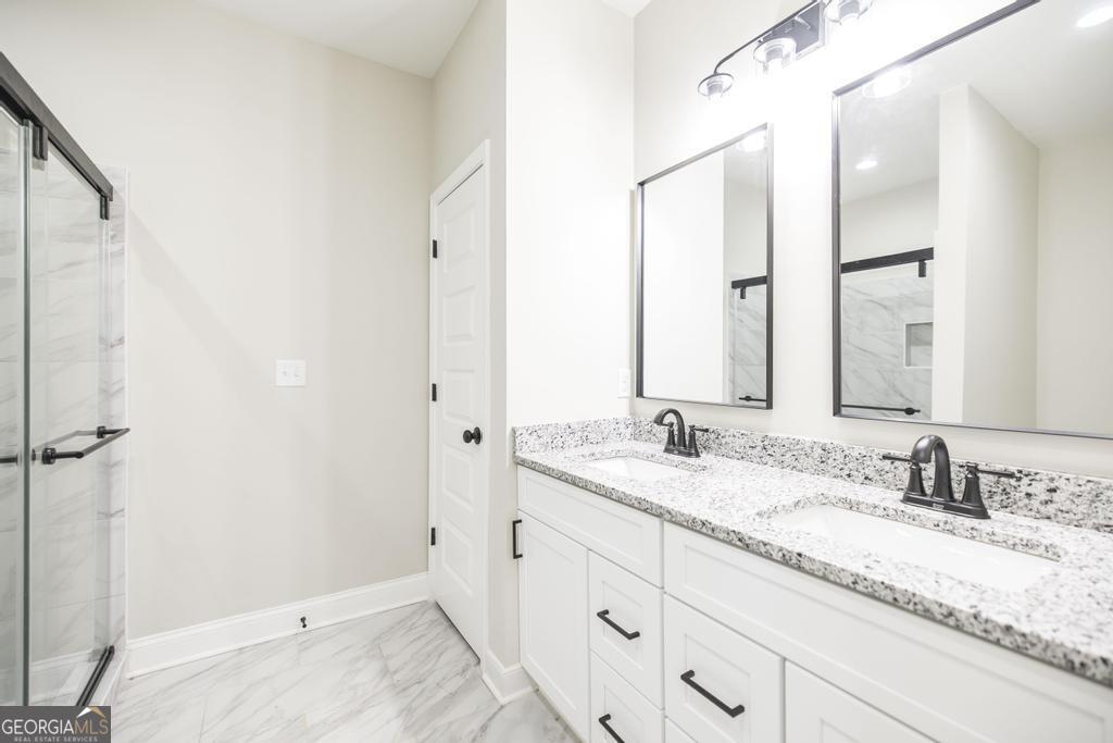 212 Lovett Farm Road East Dublin, GA 31027 - Photo 26 of 26 a bathroom with a granite countertop sink and a mirror