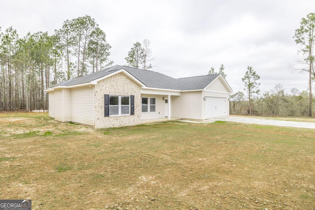 212 Lovett Farm Road East Dublin, GA 31027 - Photo 3 of 26 a house that has a large pool in front of it