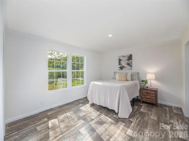 a spacious bedroom with a bed and a window