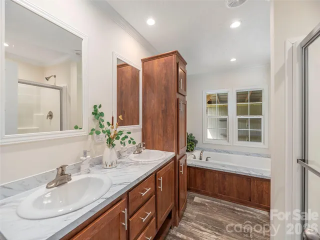 a bathroom with double vanity and a mirror