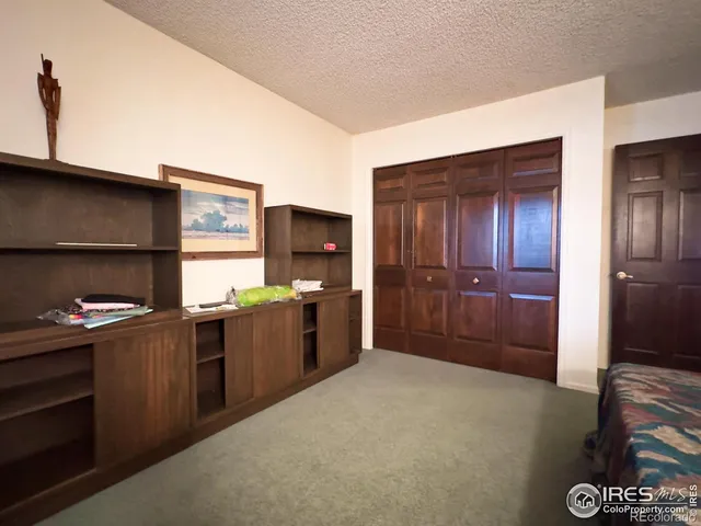 a kitchen with granite countertop a refrigerator and a stove top oven