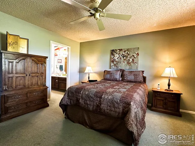 a bedroom with a bed and dresser with mirror