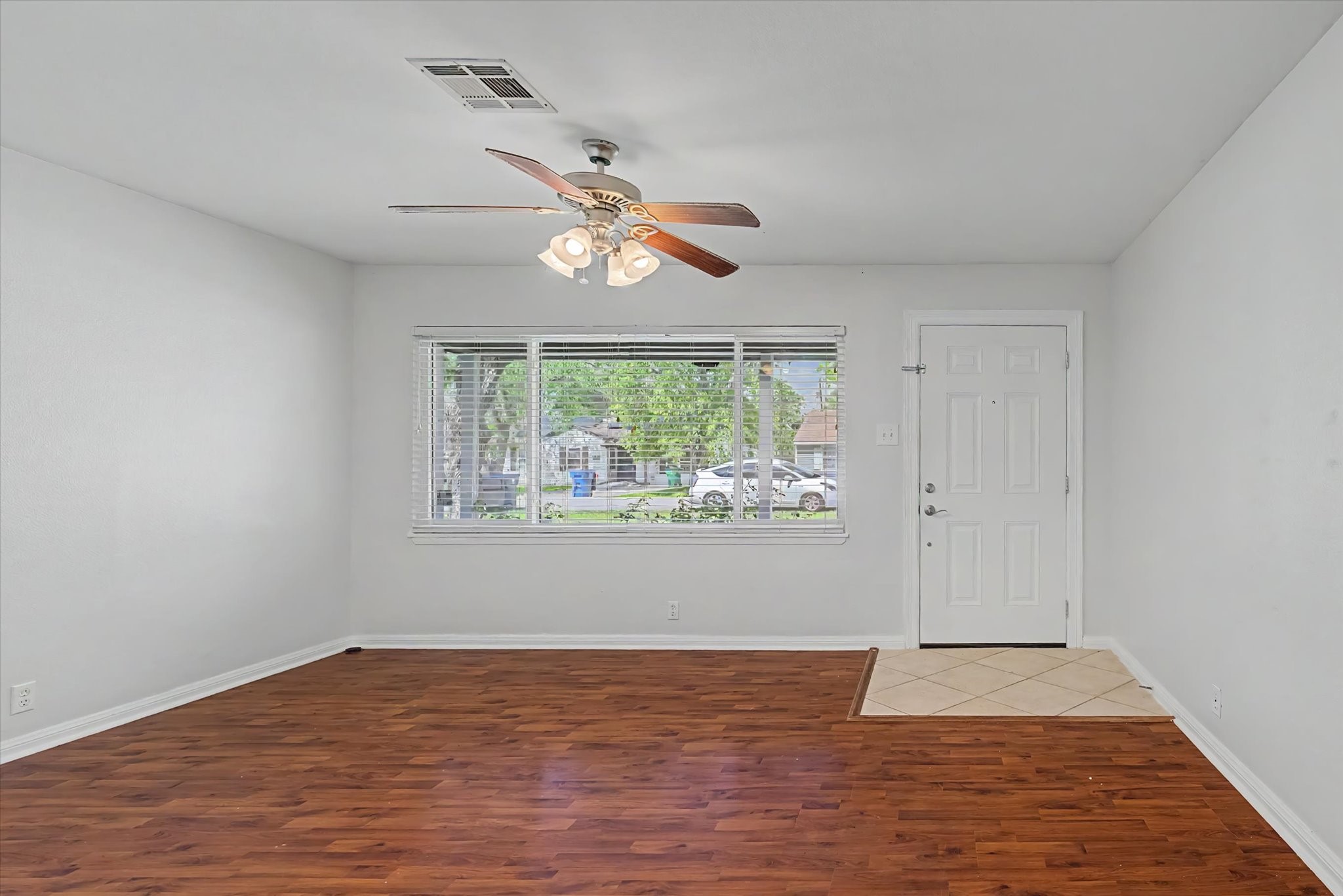 413 Farrer Street Angleton, TX 77515 - Photo 8 of 43 a view of an empty room window and wooden floor