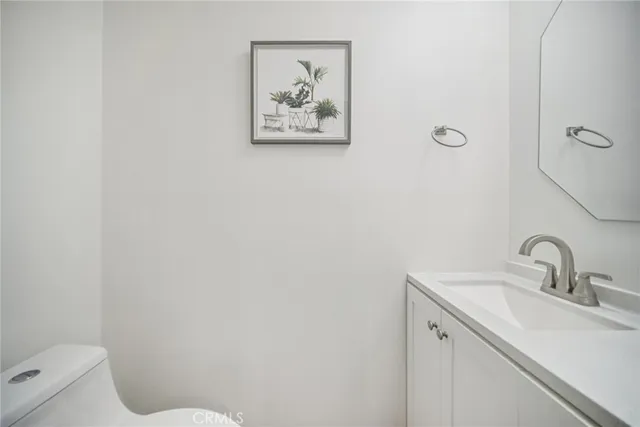 a bathroom with a sink mirror and toilet