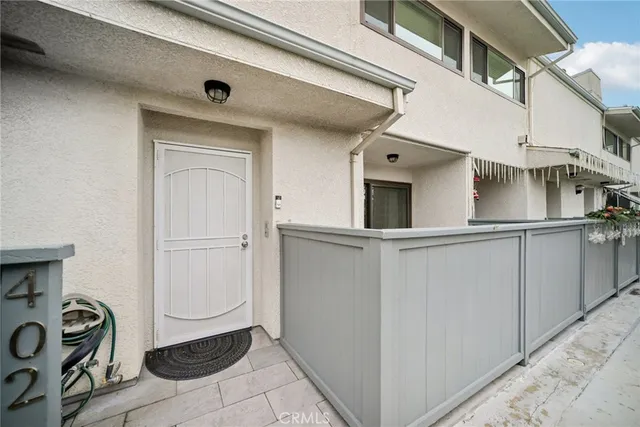 a view of a cars park in front of a building