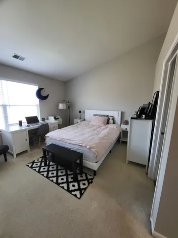 a bed sitting in a room next to a window