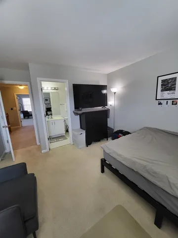 a bedroom with furniture and a flat screen tv